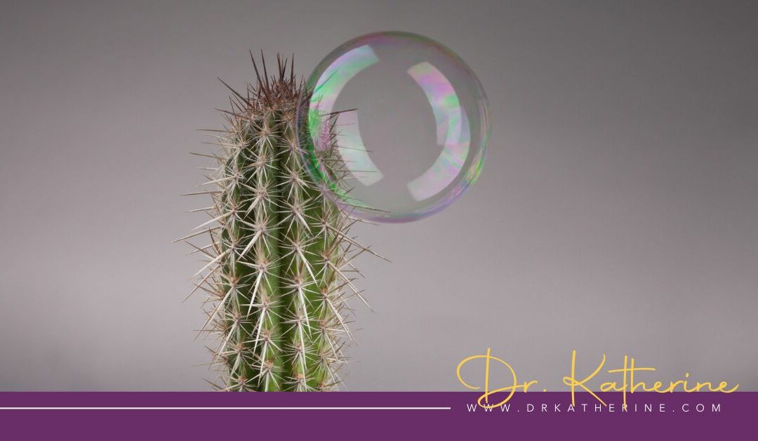 The Avoidance Mindset - Photo of a cactus with a bubble resting on it. A purple footer can be seen with the Dr. Katherine signature in yellow and www.drkatherine.com underneath that