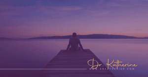 Purple image of man sitting on a dock looking out to a river and hills