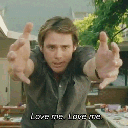 GIF: Jim Carey saying "Love me. Love me." with his arms outstretched